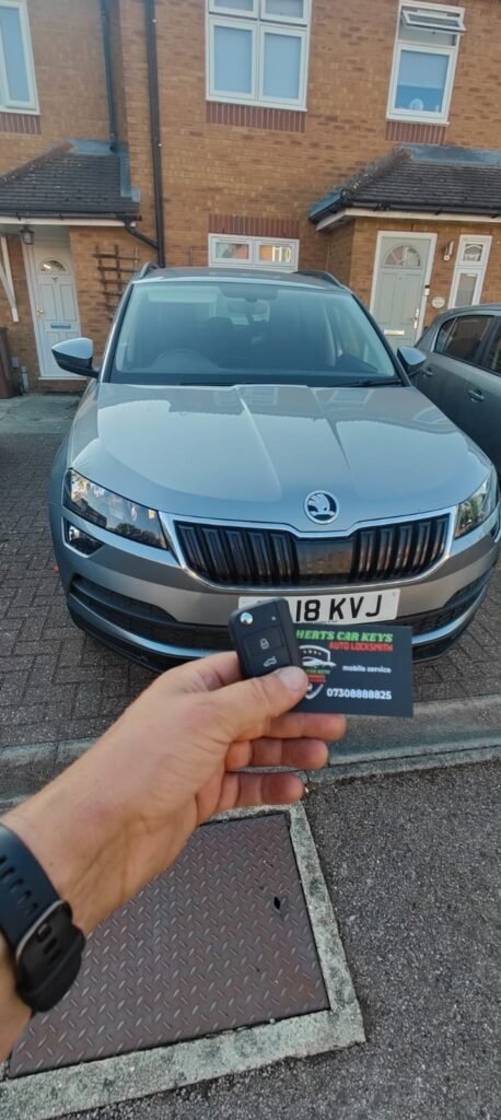 Car key held in front of a 2018 Skoda Karoq