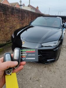 Spare key for a 2020 Lamborghini Urus held in front of the car